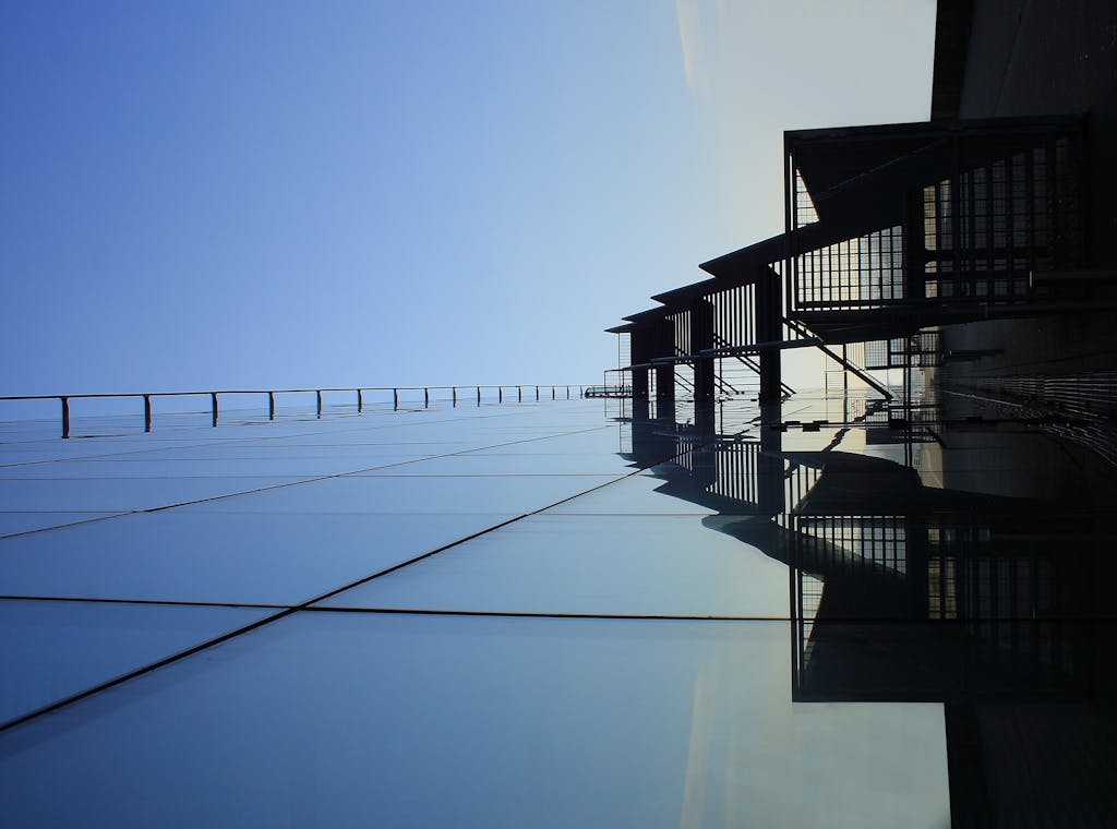 A striking glass skyscraper reflecting blue skies, showcasing modern architecture's elegance.